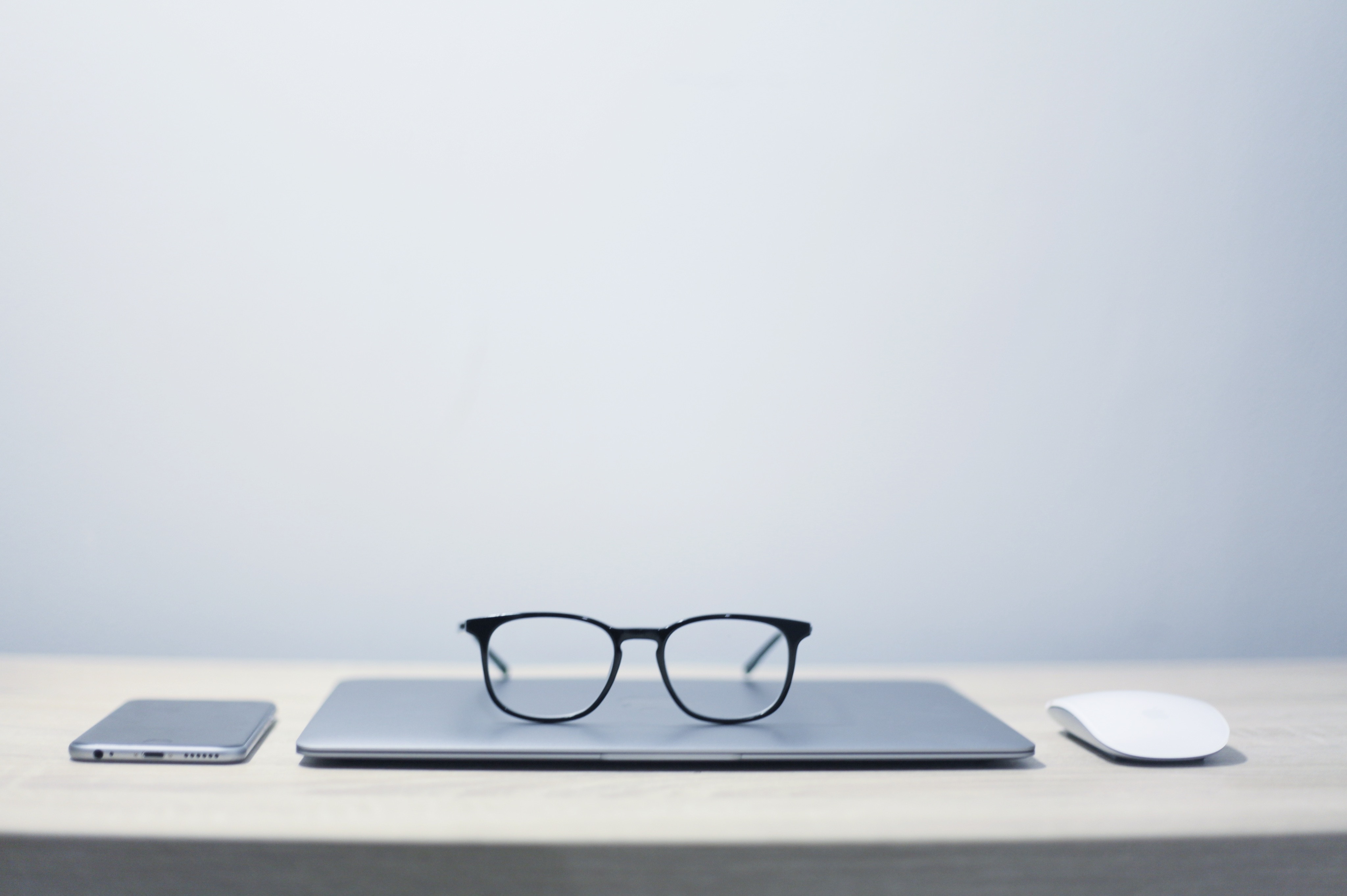 Image of close laptop with pair of glasses on top