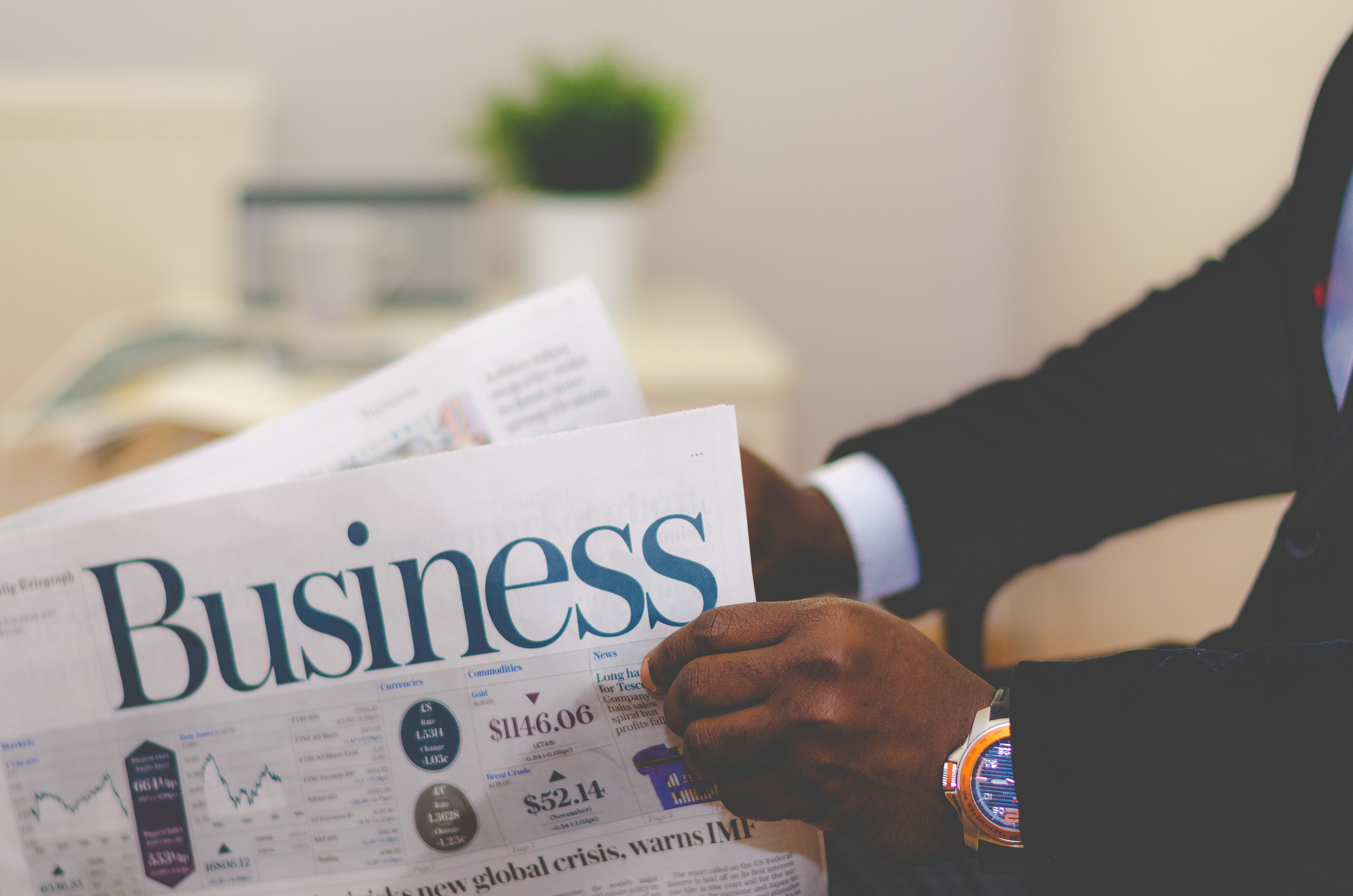 Hands of a man with business newspaper