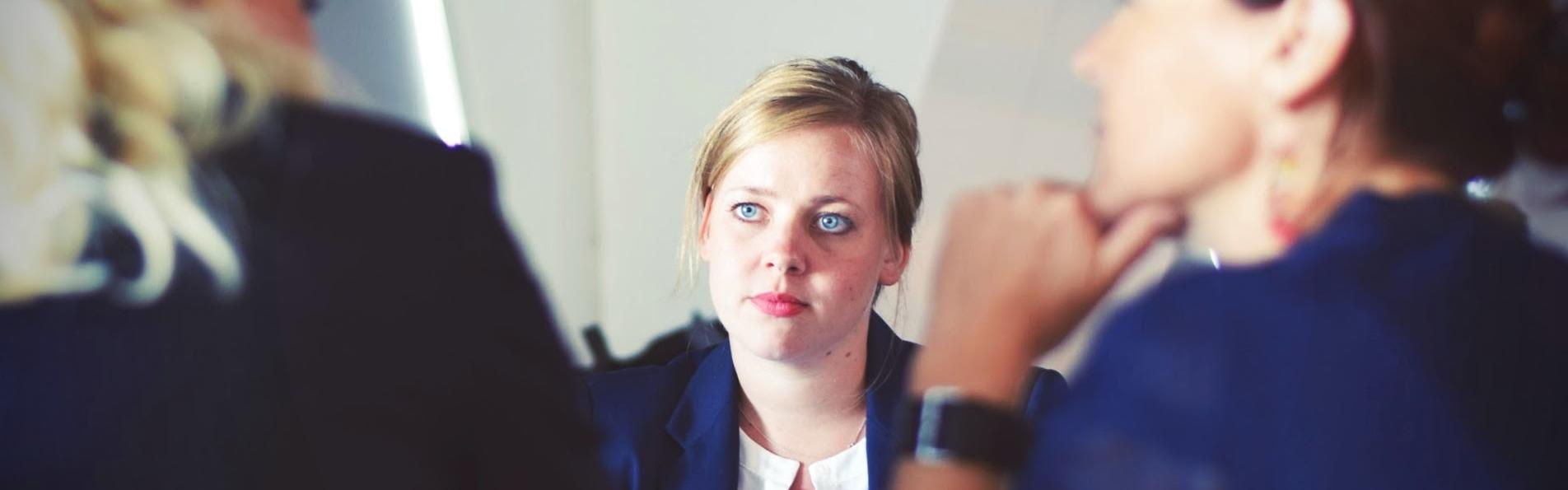 Three women sat at a table talking about mediation