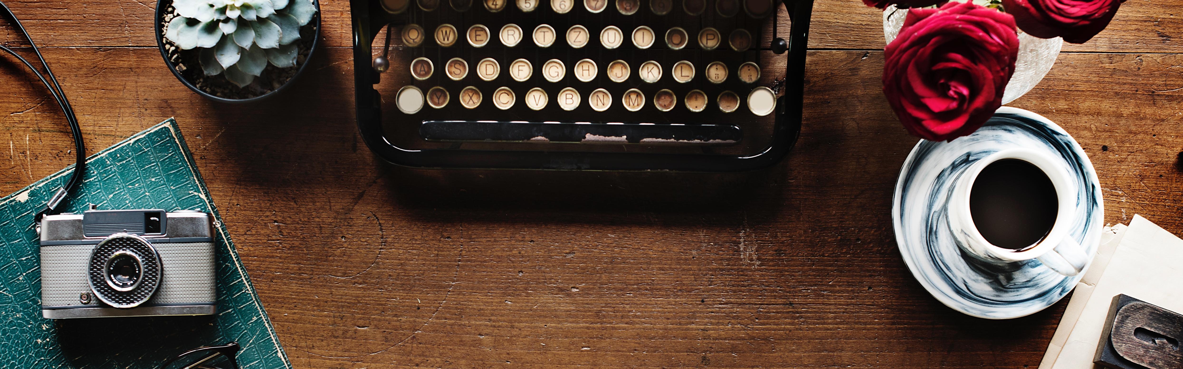 Desk with vintage type writer, camera, and other objects